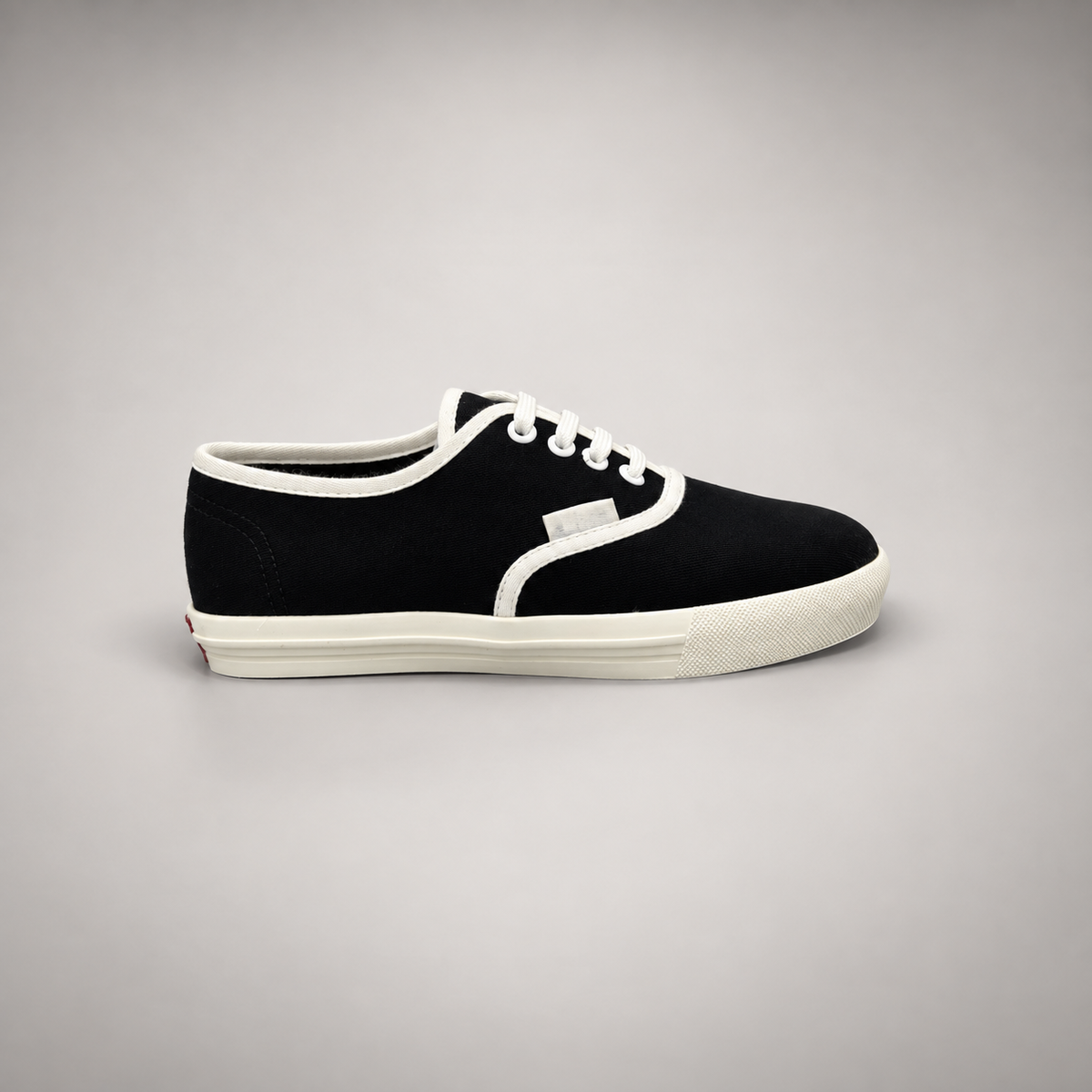Black canvas lace-up sneakers, side view