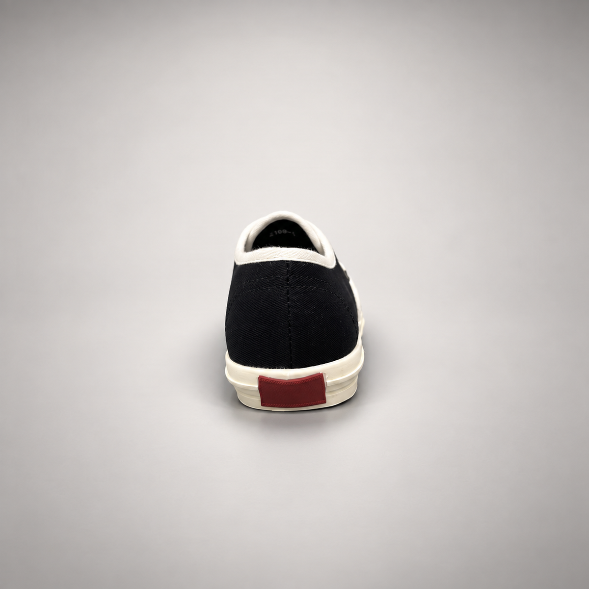 Black canvas lace-up sneakers, back view