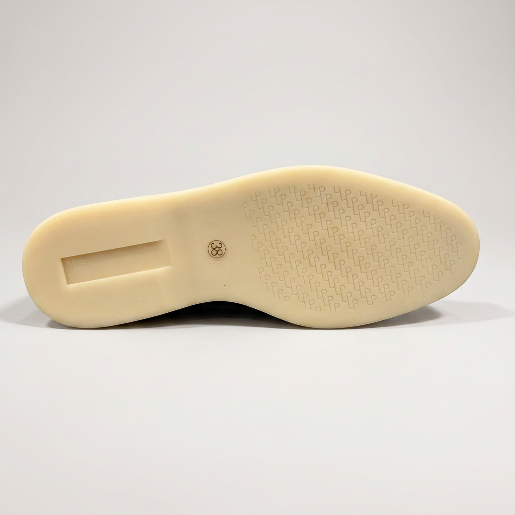 Black loafer outsole view showing the rubber outsole