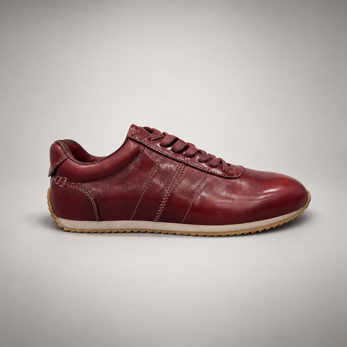 Burgundy low-top lace-up sneaker side view