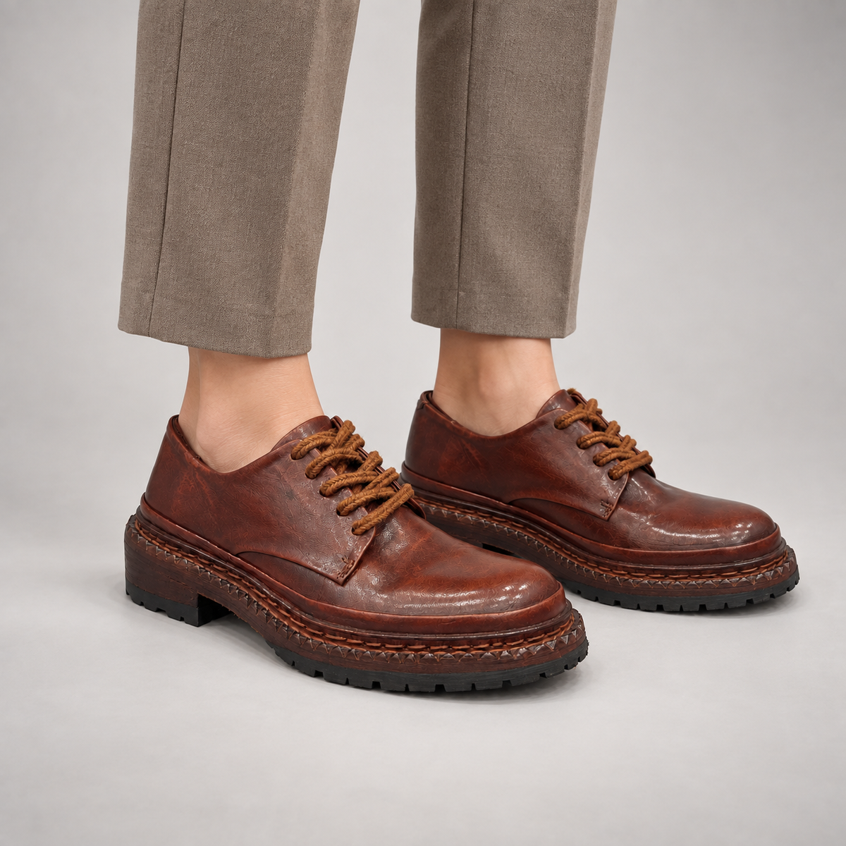 Brown washed leather platform lace-up shoes worn on foot