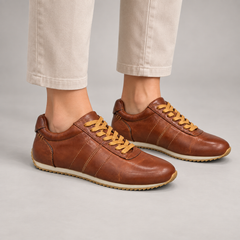 Brown washed leather lace-up sneakers worn on foot