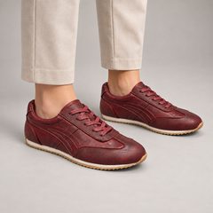 Burgundy washed leather lace-up sneakers worn on foot