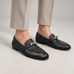 Black washed leather horsebit loafers worn on foot