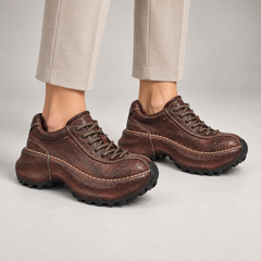 Brown washed leather platform lace-up shoes worn on foot