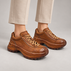 Tan washed leather platform lace-up shoes worn on foot