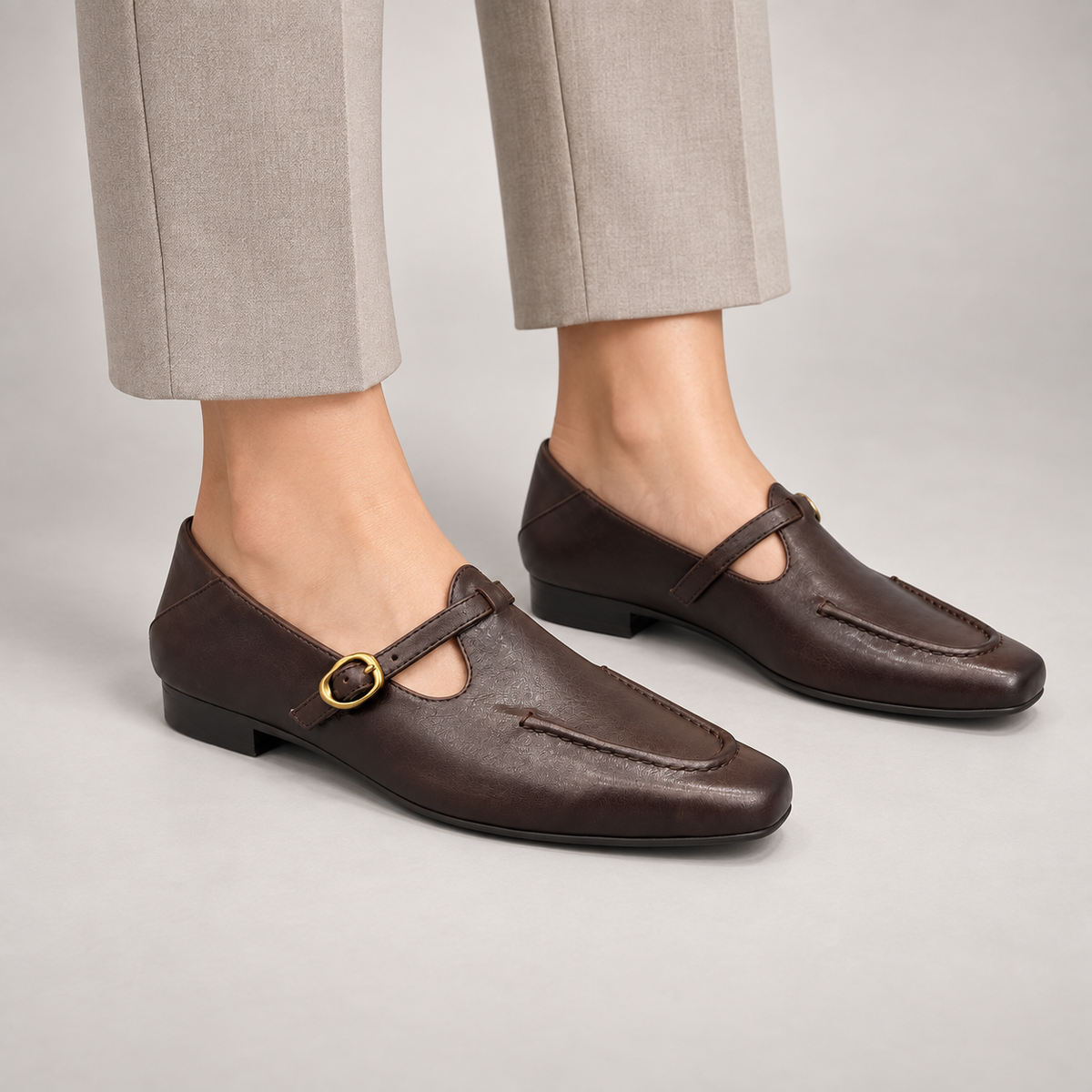 Dark brown leather buckle-strap shoes worn on foot