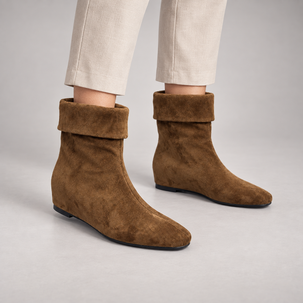 Brown suede fold-over mid-calf boots worn on foot