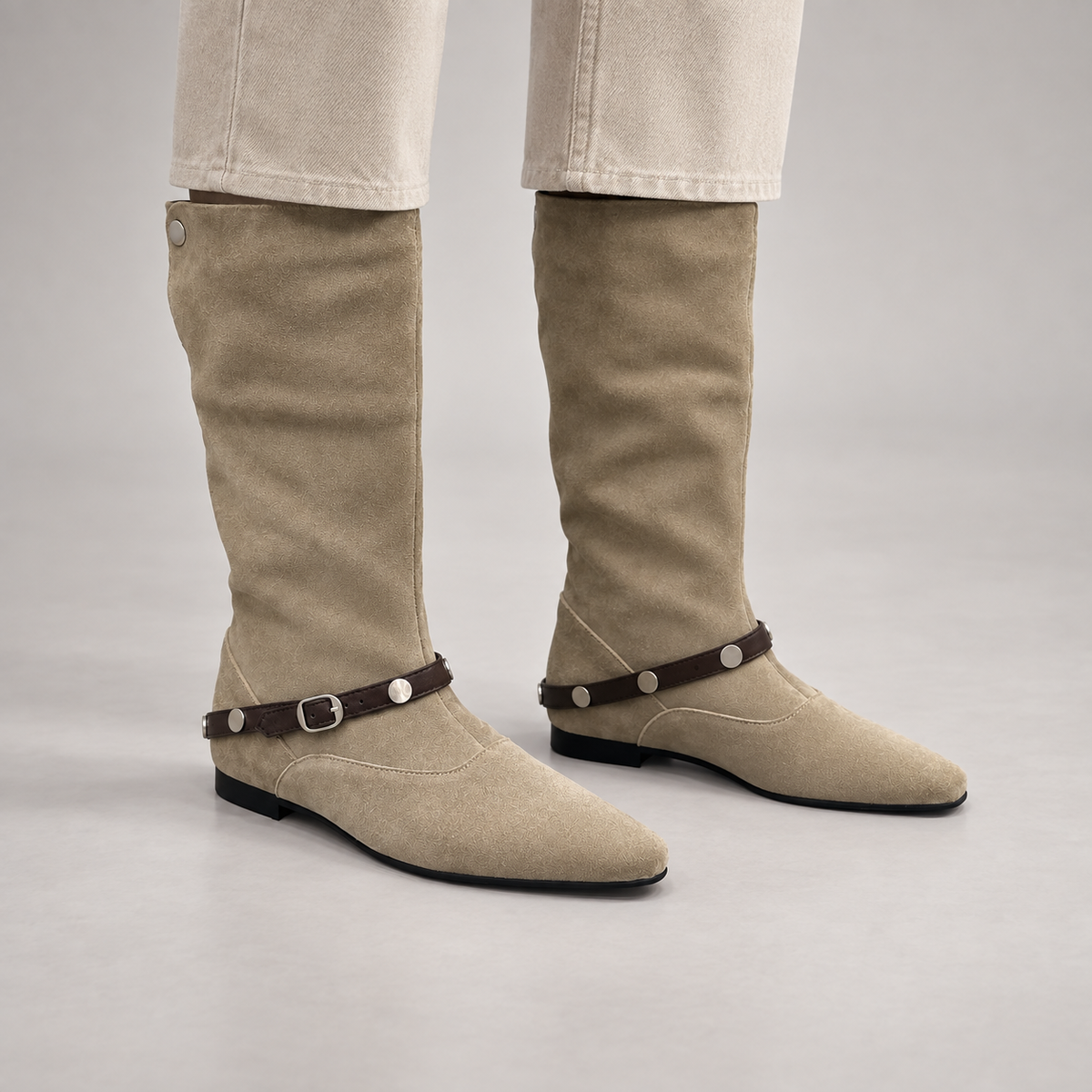 Beige suede knee-high boots worn on foot