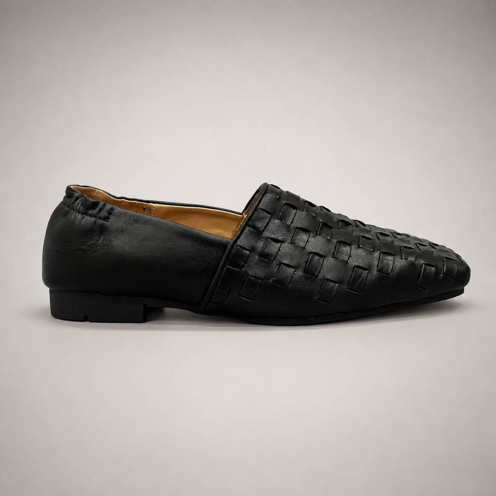 Black woven loafer side profile showing a woven slip-on upper