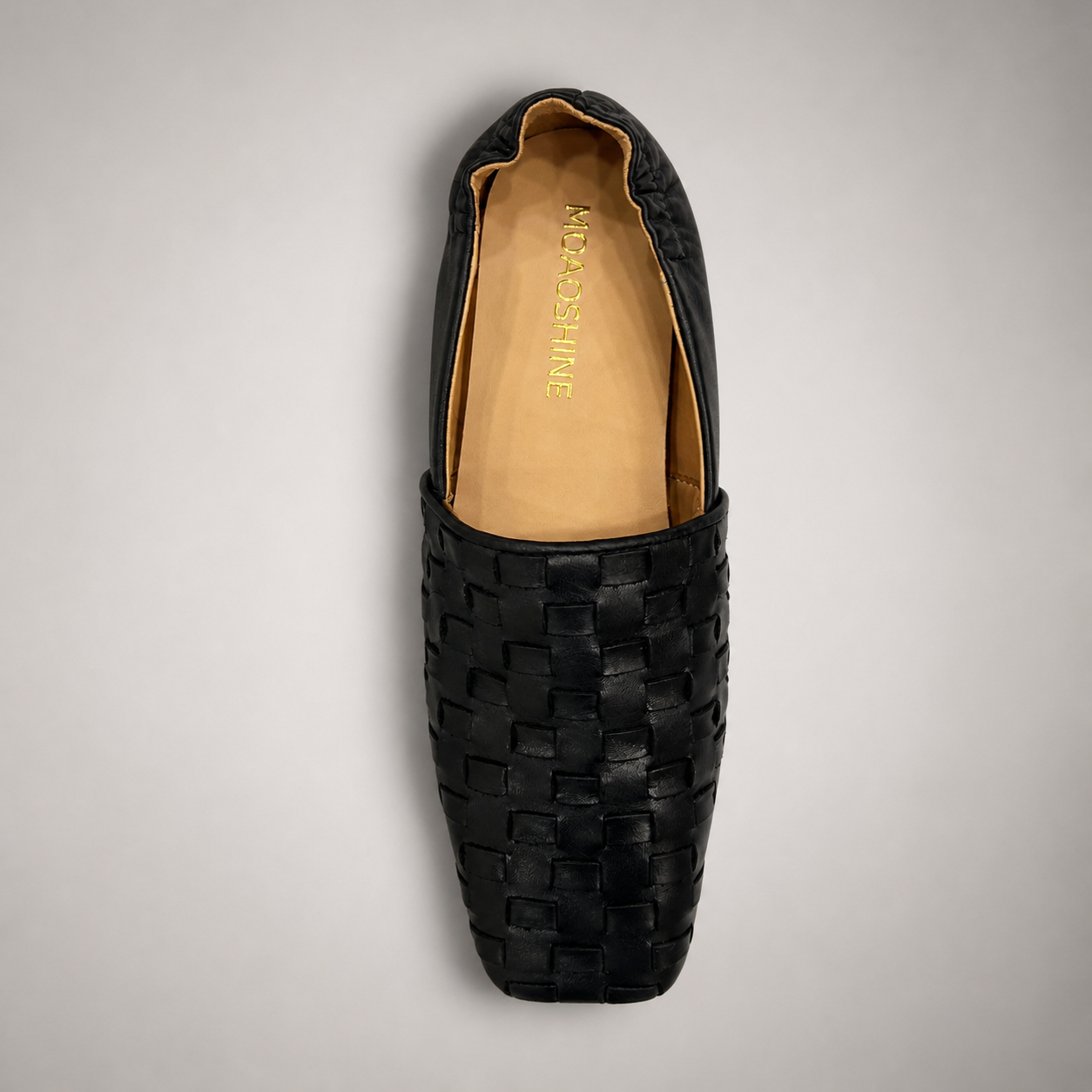 Black woven loafer top view showing a woven slip-on upper