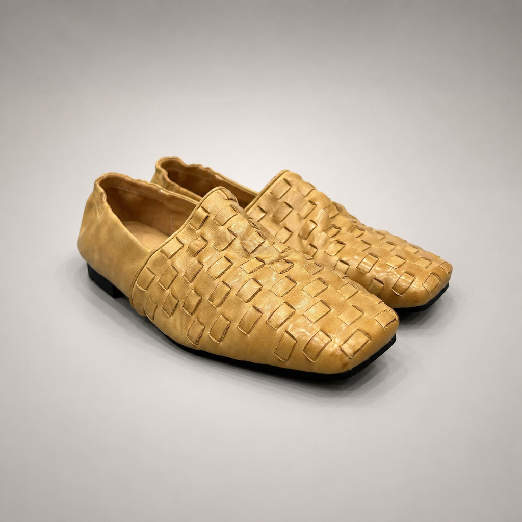 Gold woven loafer pair three-quarter view showing a woven slip-on upper