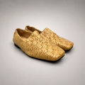 Gold woven loafer pair three-quarter view showing a woven slip-on upper