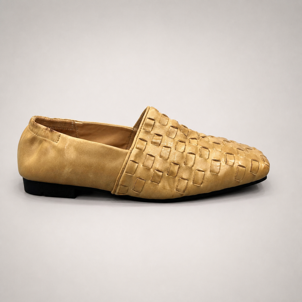 Gold woven loafer side profile showing a woven slip-on upper
