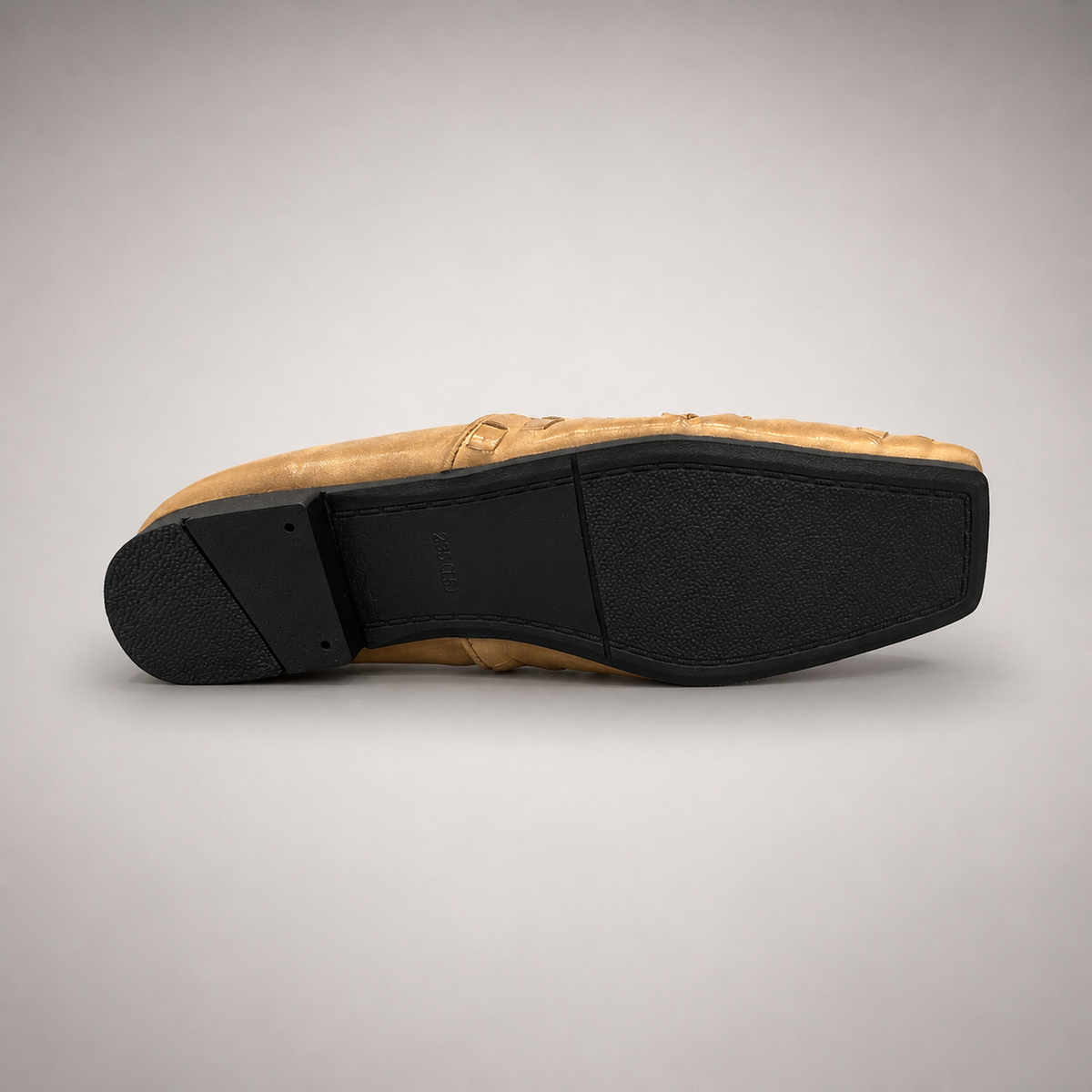 Gold woven loafer rear view showing a woven slip-on upper