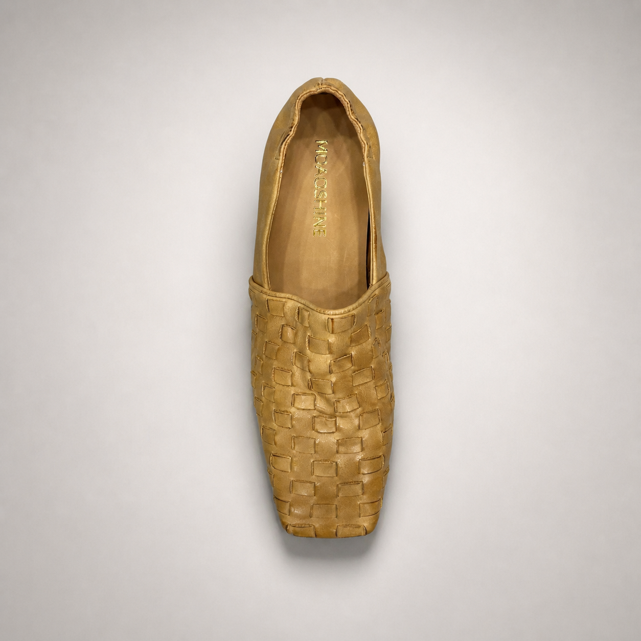 Gold woven loafer top view showing a woven slip-on upper