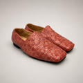 Rust woven loafer pair three-quarter view showing a woven slip-on upper