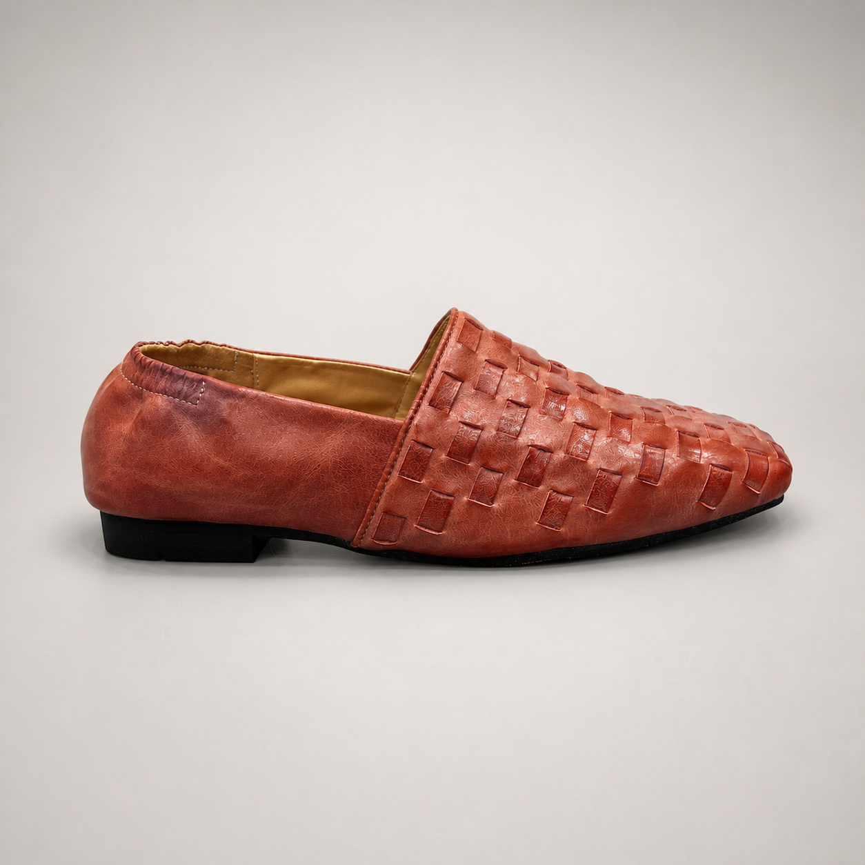 Rust woven loafer side profile showing a woven slip-on upper