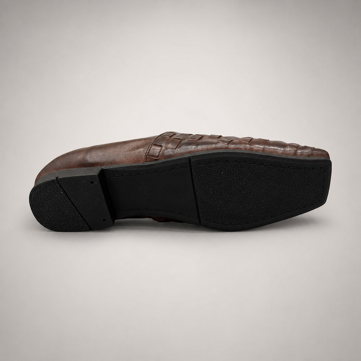 Brown woven loafer top view showing a woven slip-on upper