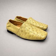 Yellow woven loafer pair three-quarter view showing a woven slip-on upper