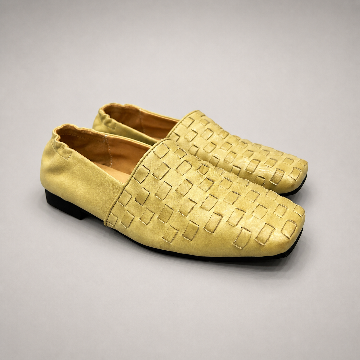 Yellow woven loafer pair three-quarter view showing a woven slip-on upper