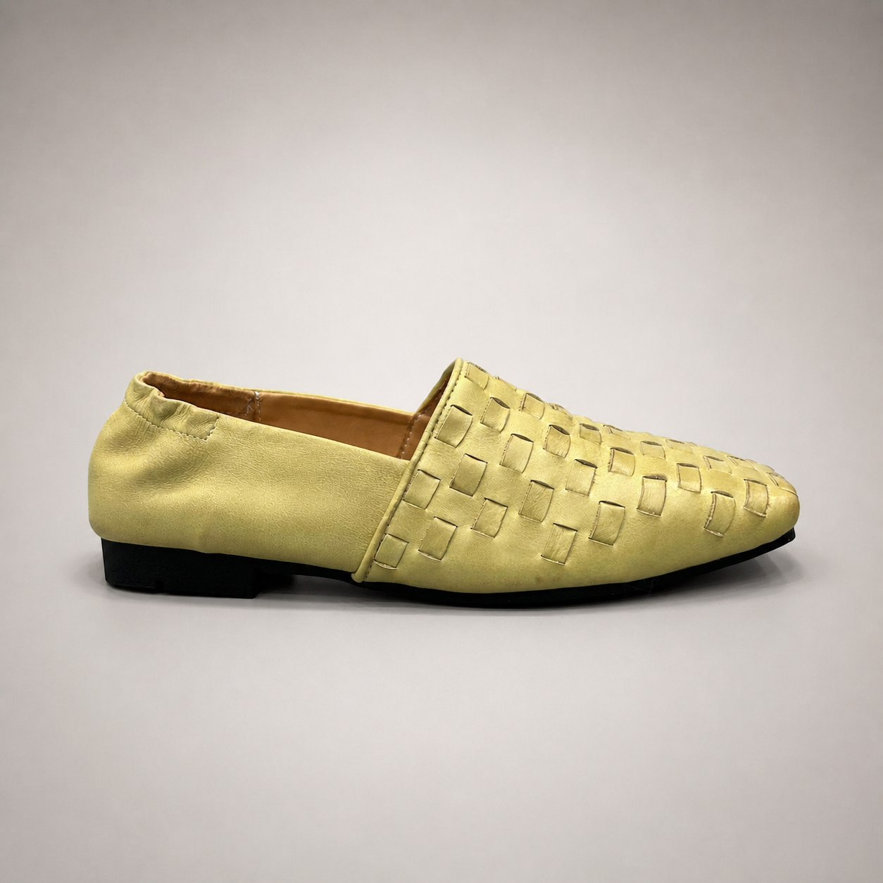 Yellow woven loafer side profile showing a woven slip-on upper