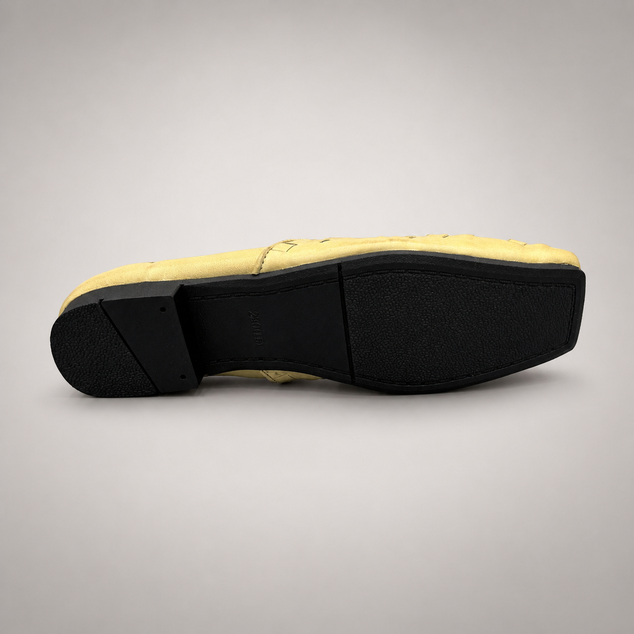 Yellow woven loafer top view showing a woven slip-on upper