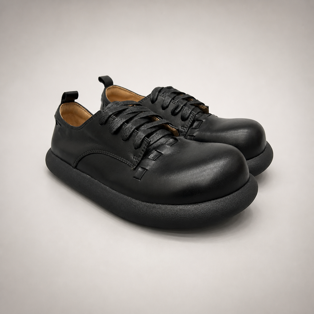 Black lace-up shoe pair three-quarter view showing a lace-up construction