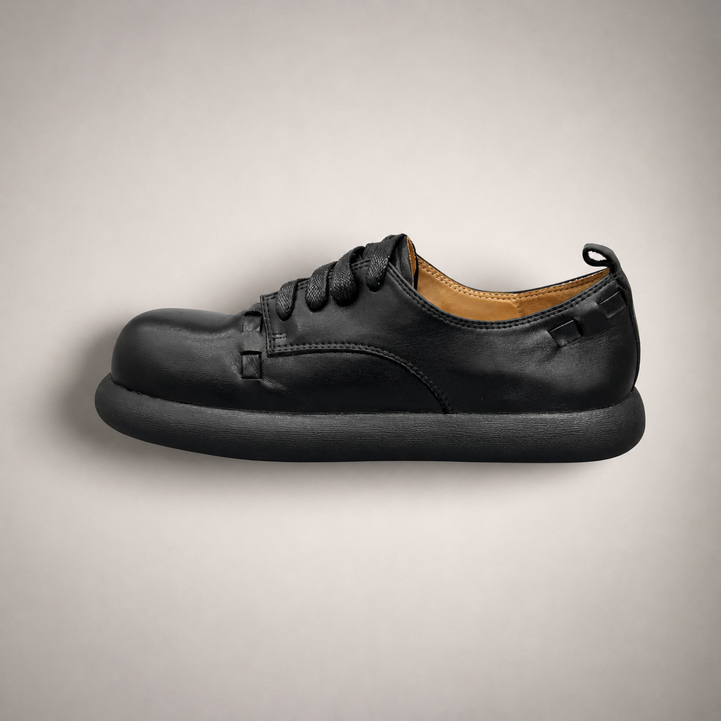 Black lace-up shoe side profile showing a lace-up construction