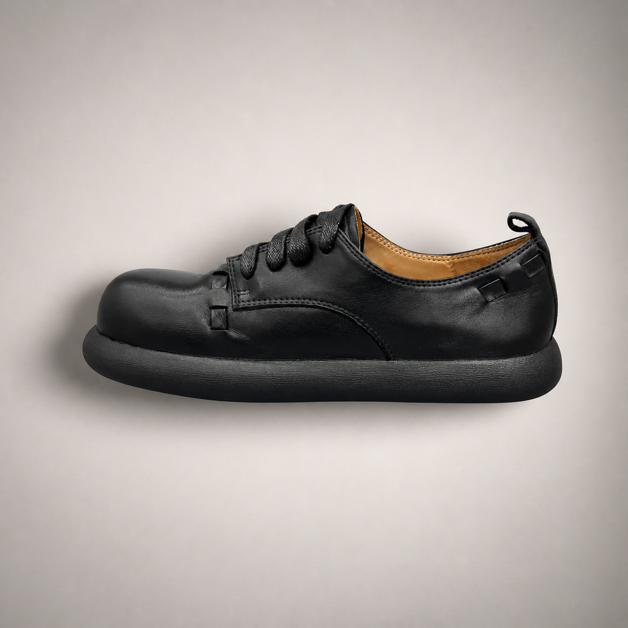 Black lace-up shoe side profile showing a lace-up construction