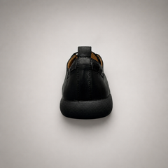 Black lace-up shoe rear view showing a lace-up construction