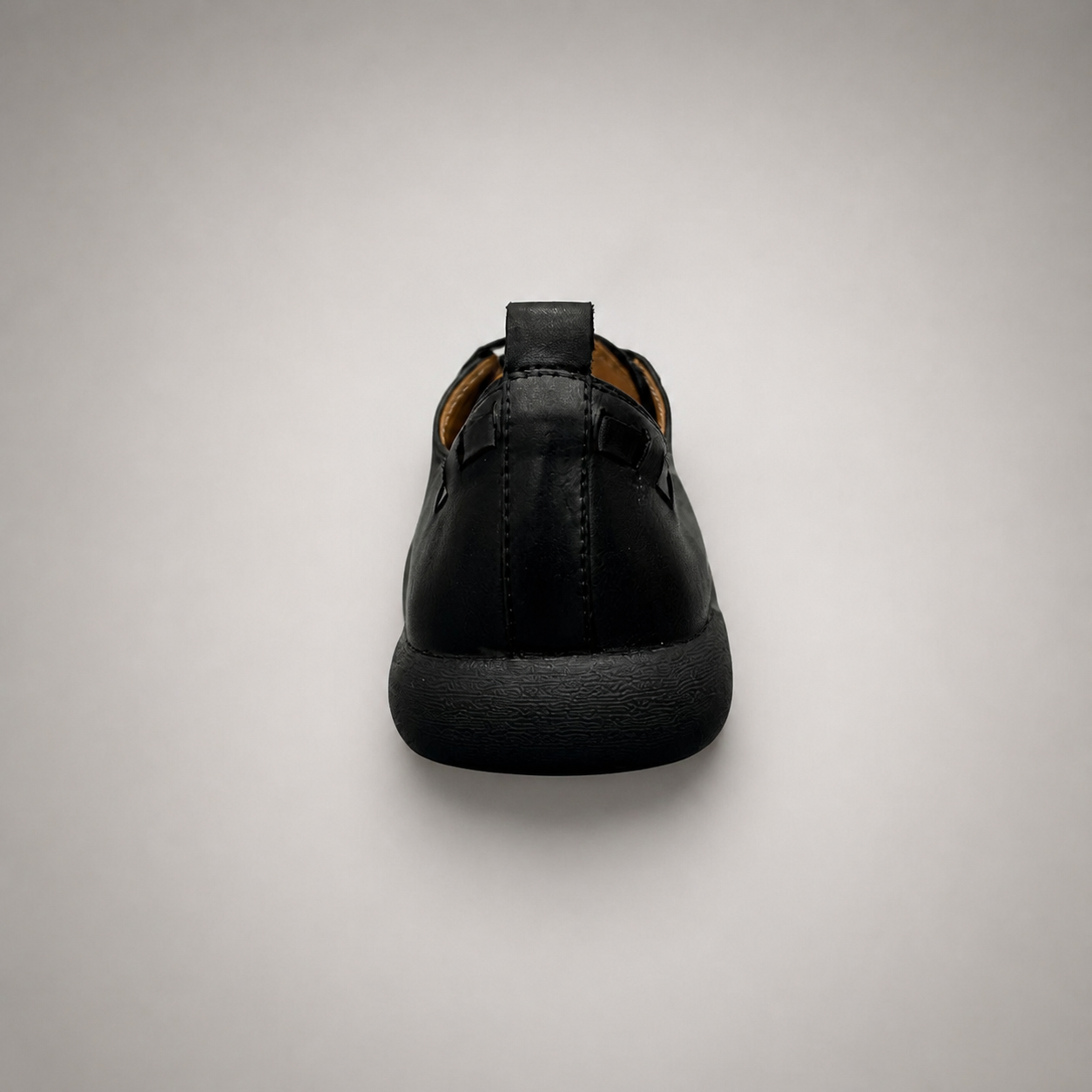 Black lace-up shoe rear view showing a lace-up construction