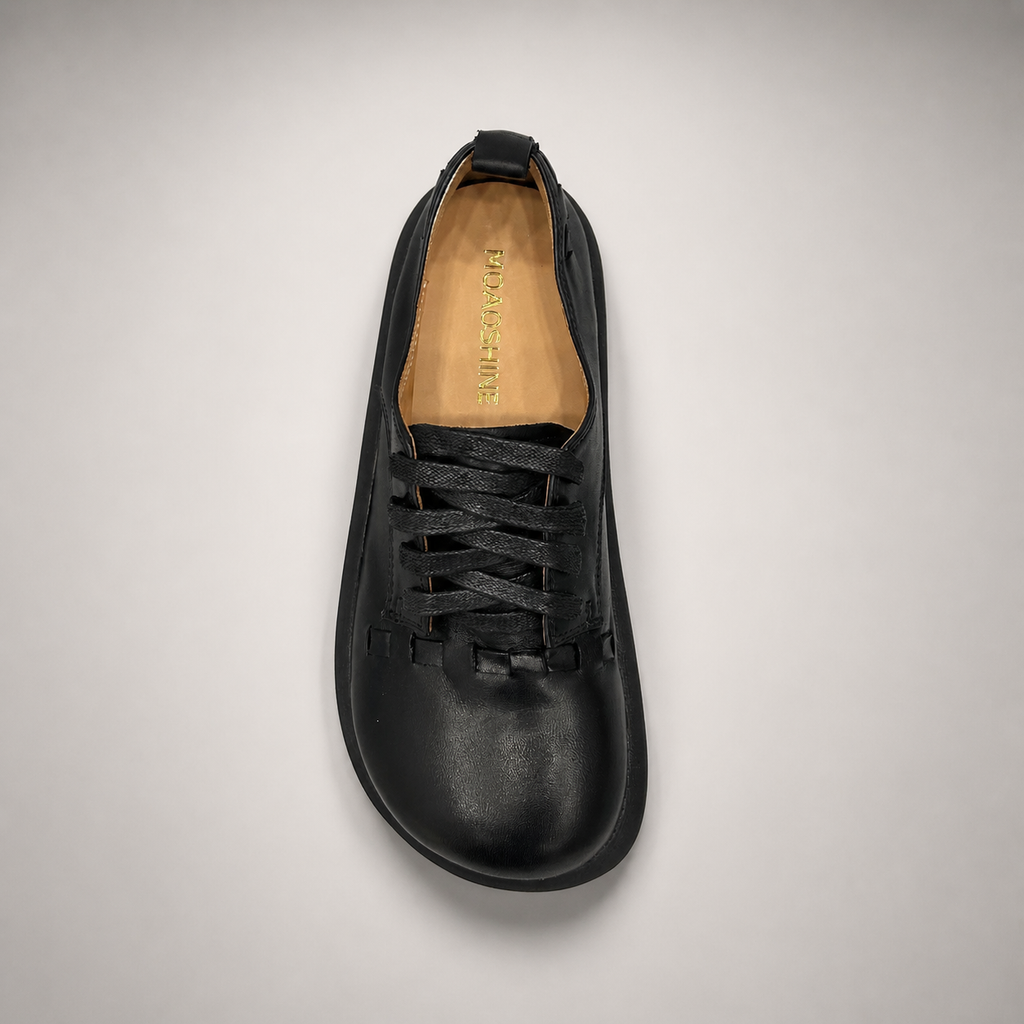 Black lace-up shoe top view showing a lace-up construction