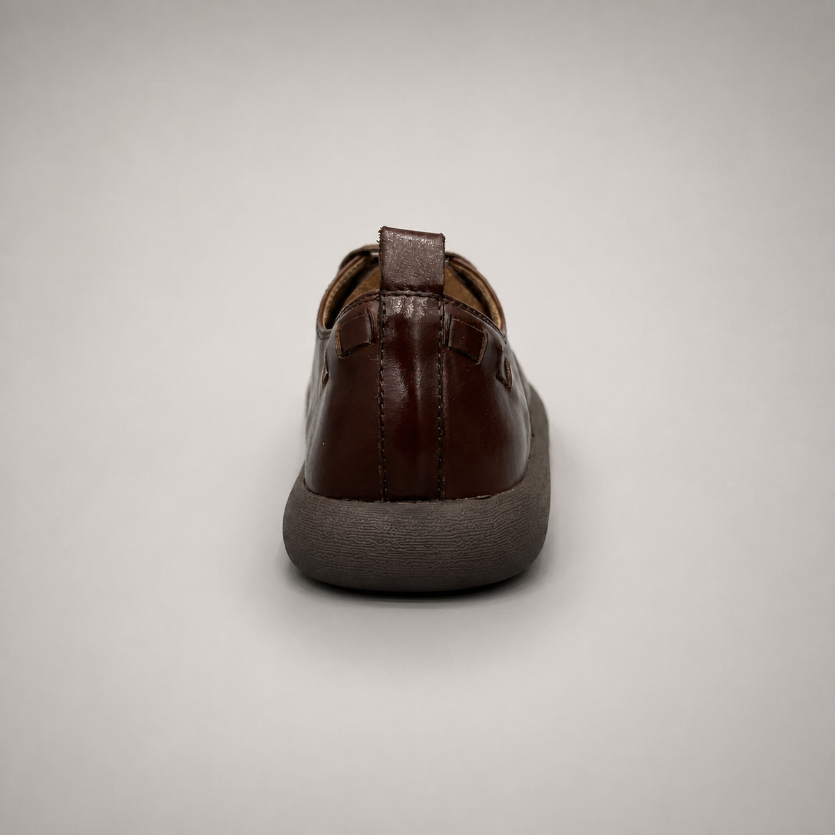 Brown lace-up shoe rear view showing a lace-up construction