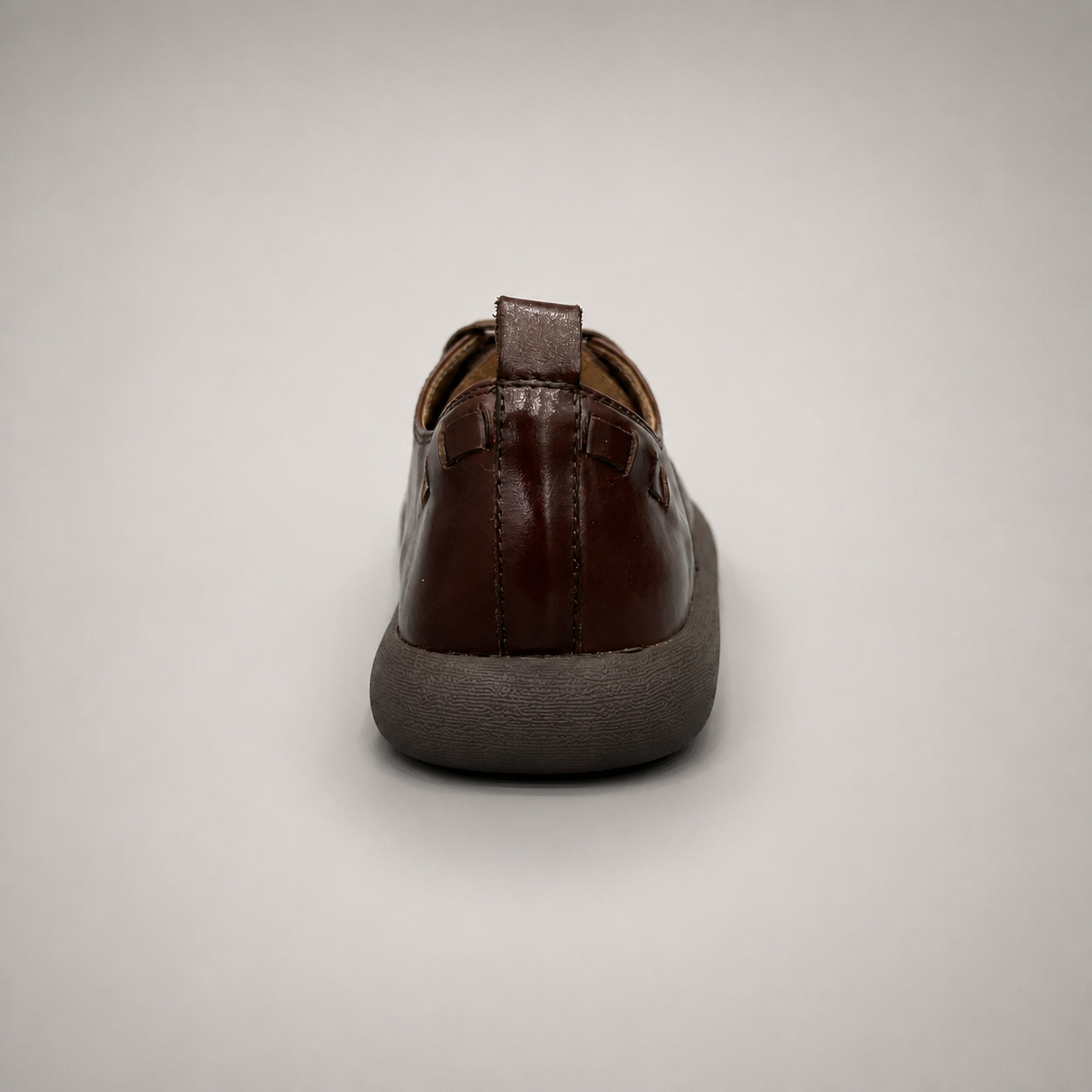 Brown lace-up shoe rear view showing a lace-up construction