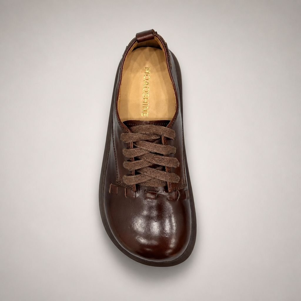 Brown lace-up shoe outsole view showing the rubber outsole