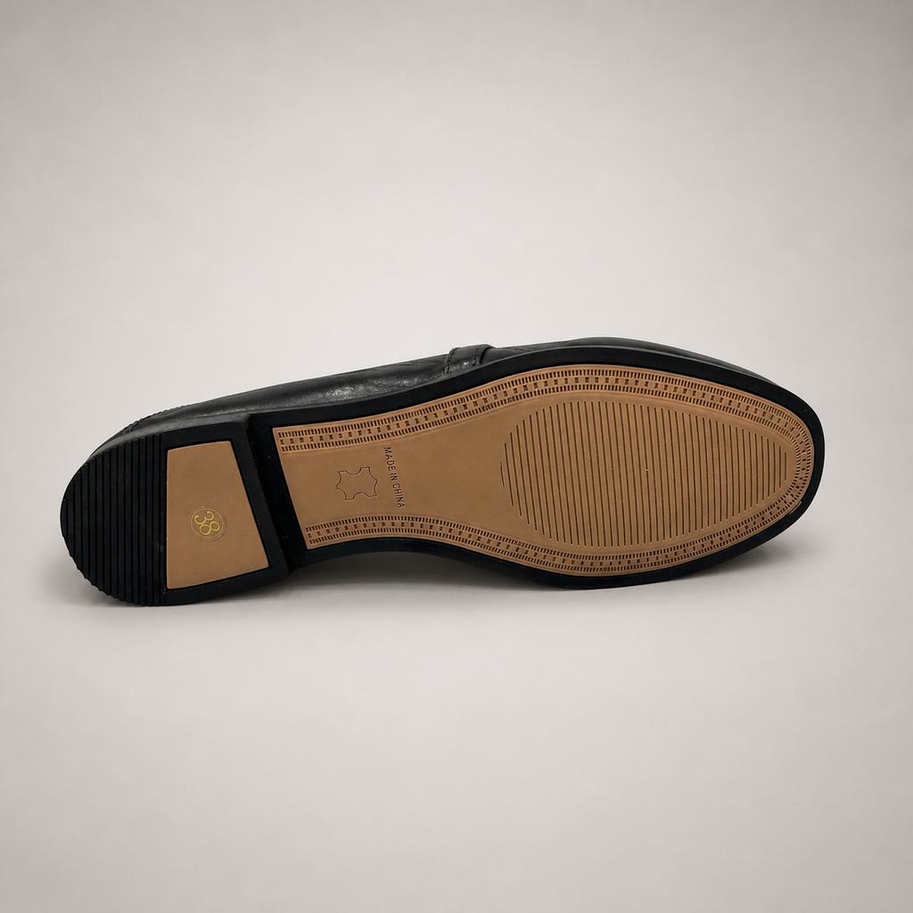 Black loafer outsole view showing the cow leather outsole