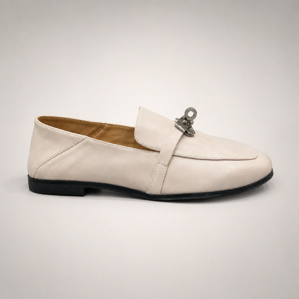 Ivory loafer side profile showing a metal accent across the vamp