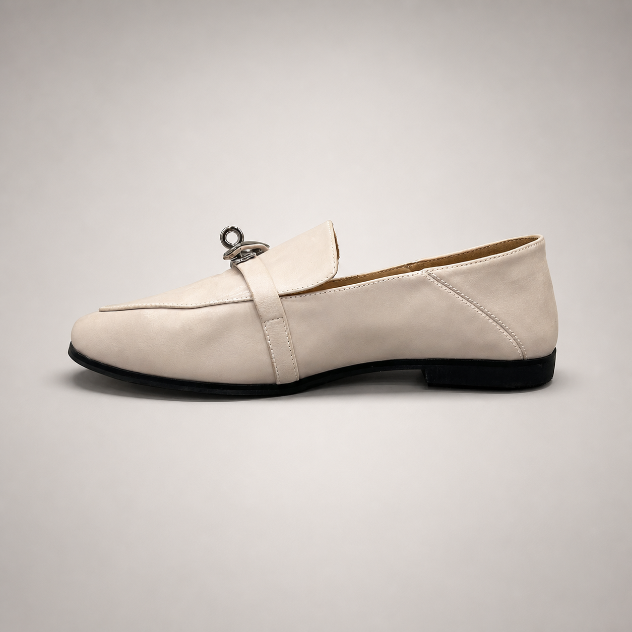 Ivory loafer opposite side profile showing a metal accent across the vamp