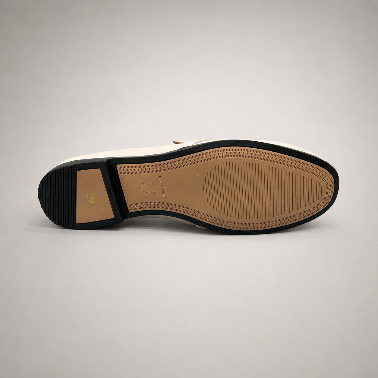 Ivory loafer outsole view showing the cow leather outsole