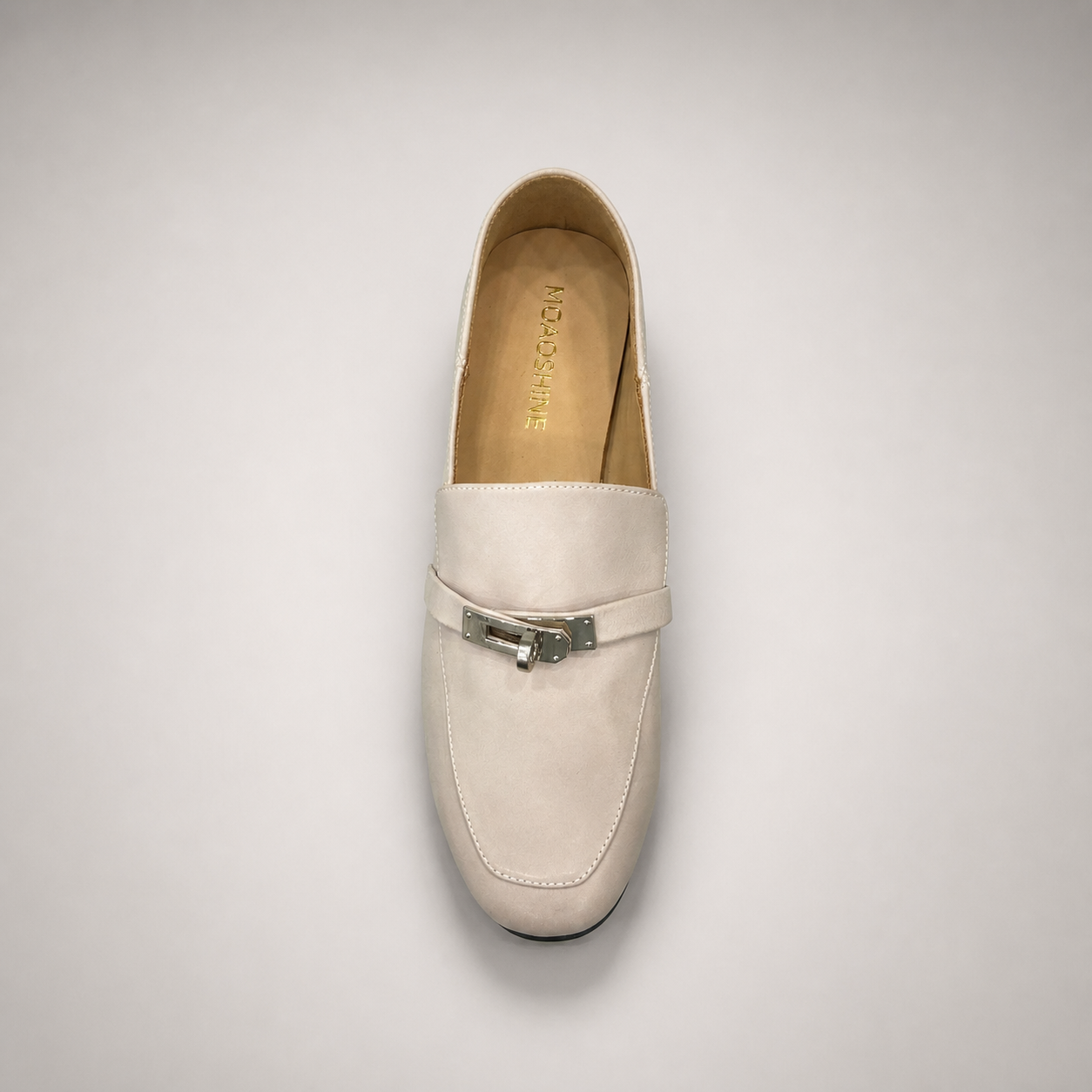 Ivory loafer top view showing a metal accent across the vamp
