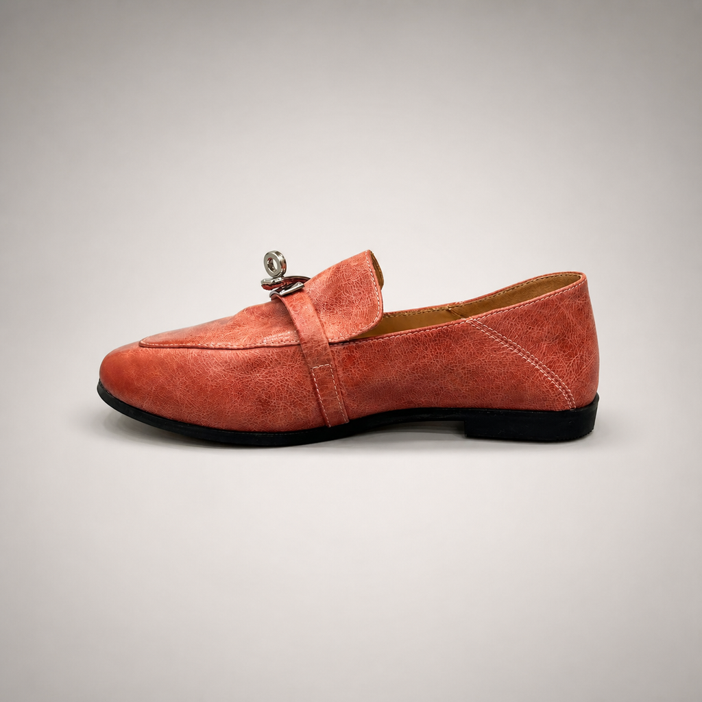 Rust loafer side profile showing a metal accent across the vamp