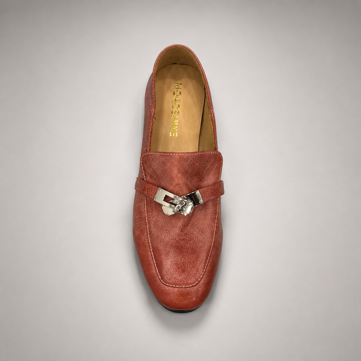 Rust loafer top view showing a metal accent across the vamp