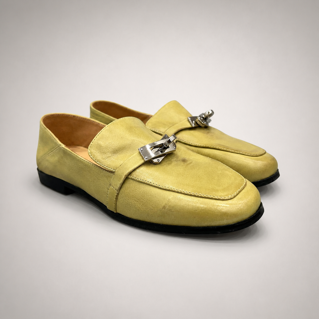 Yellow loafer pair three-quarter view showing a metal accent across the vamp
