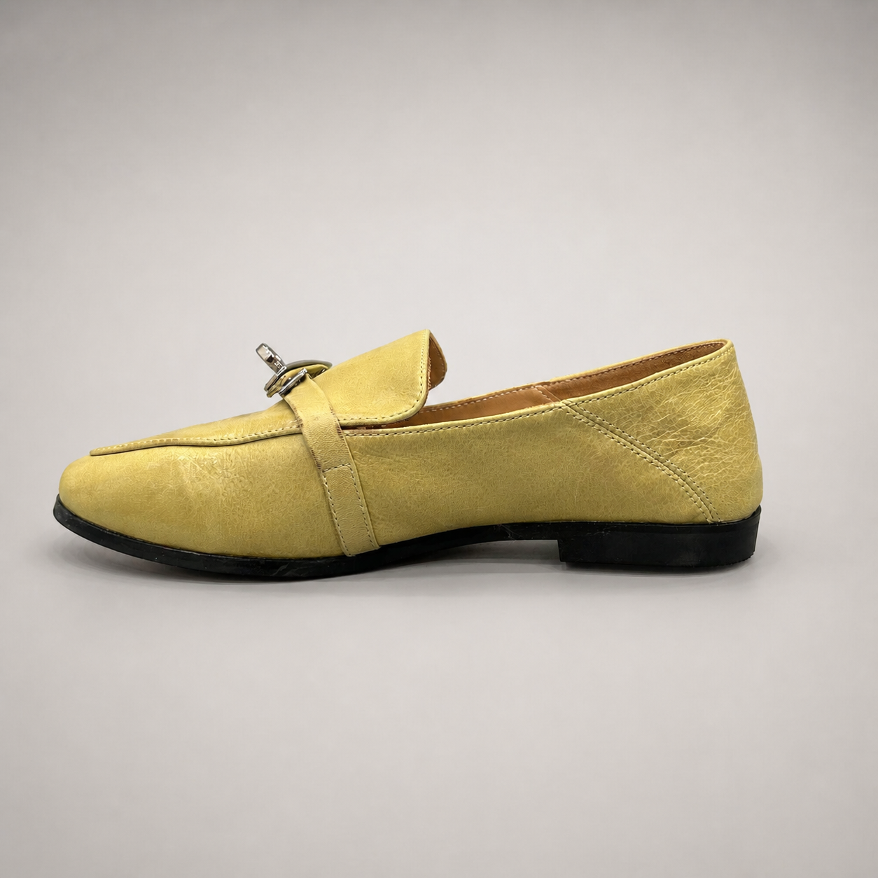 Yellow loafer opposite side profile showing a metal accent across the vamp