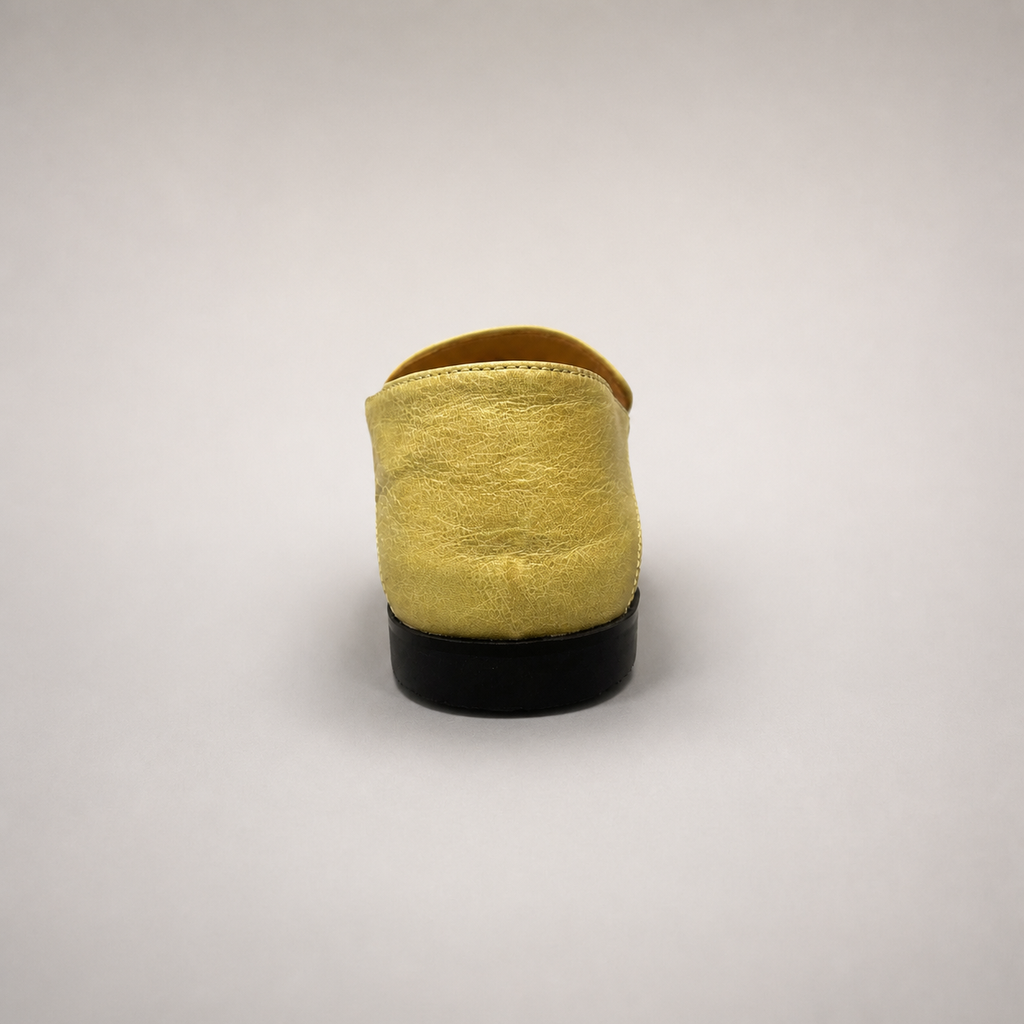 Yellow loafer rear view showing a metal accent across the vamp