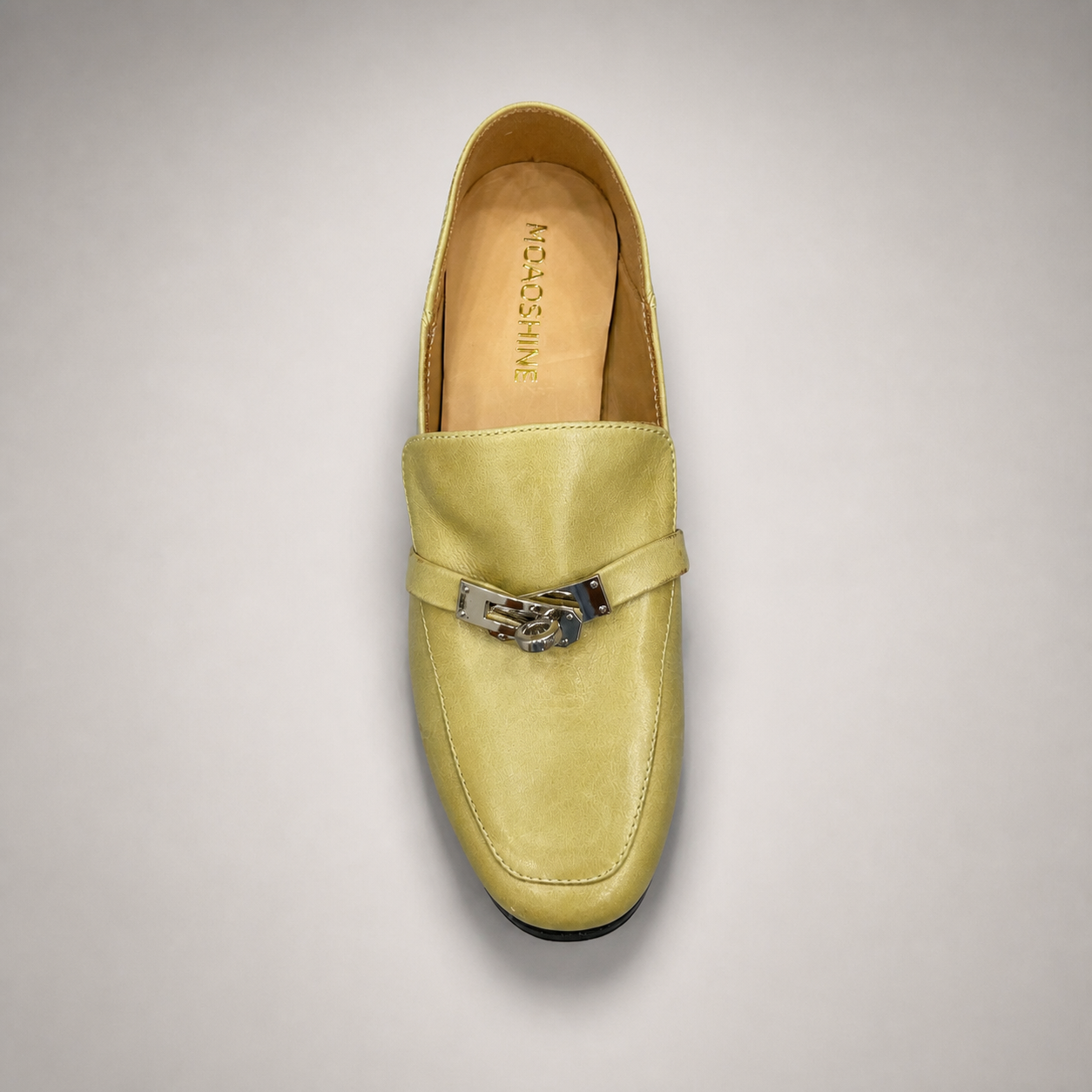 Yellow loafer top view showing a metal accent across the vamp