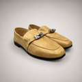 Tan loafer pair three-quarter view showing a metal accent across the vamp
