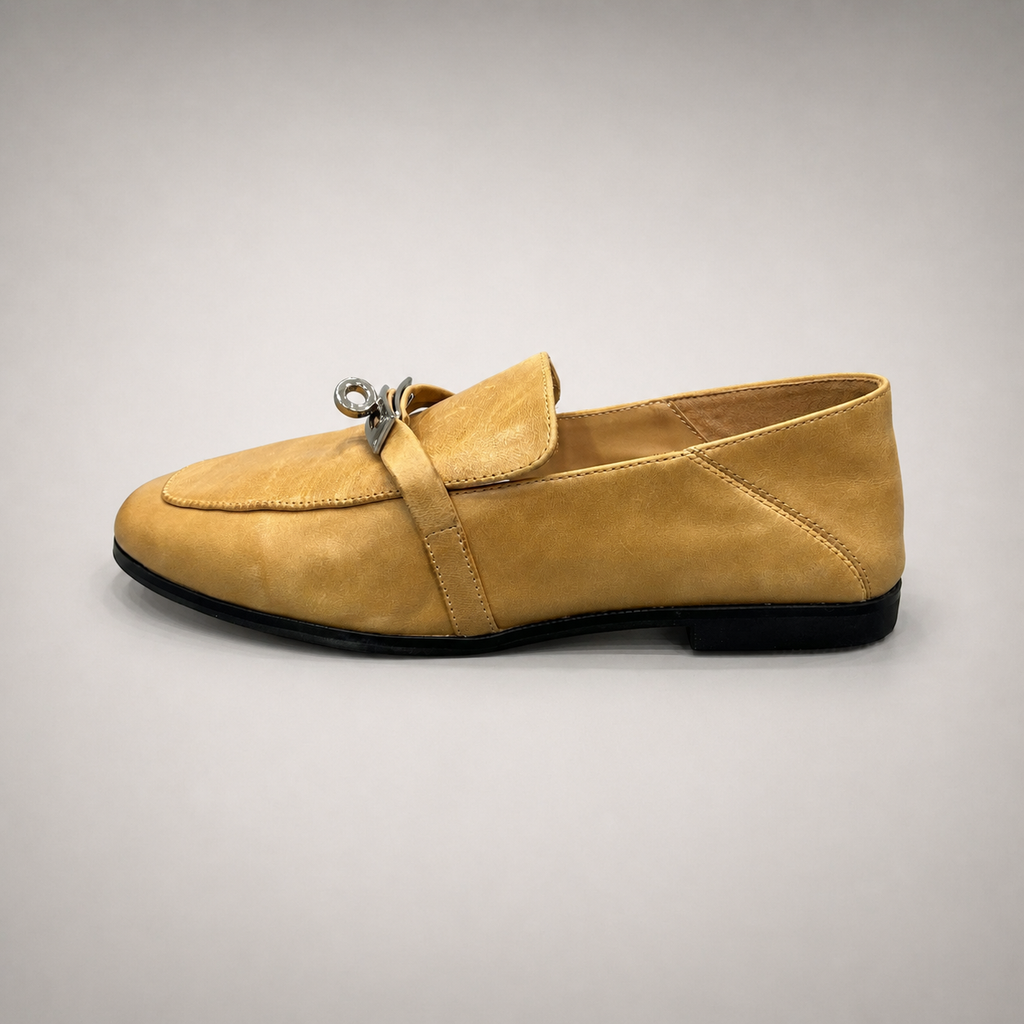 Tan loafer side profile showing a metal accent across the vamp