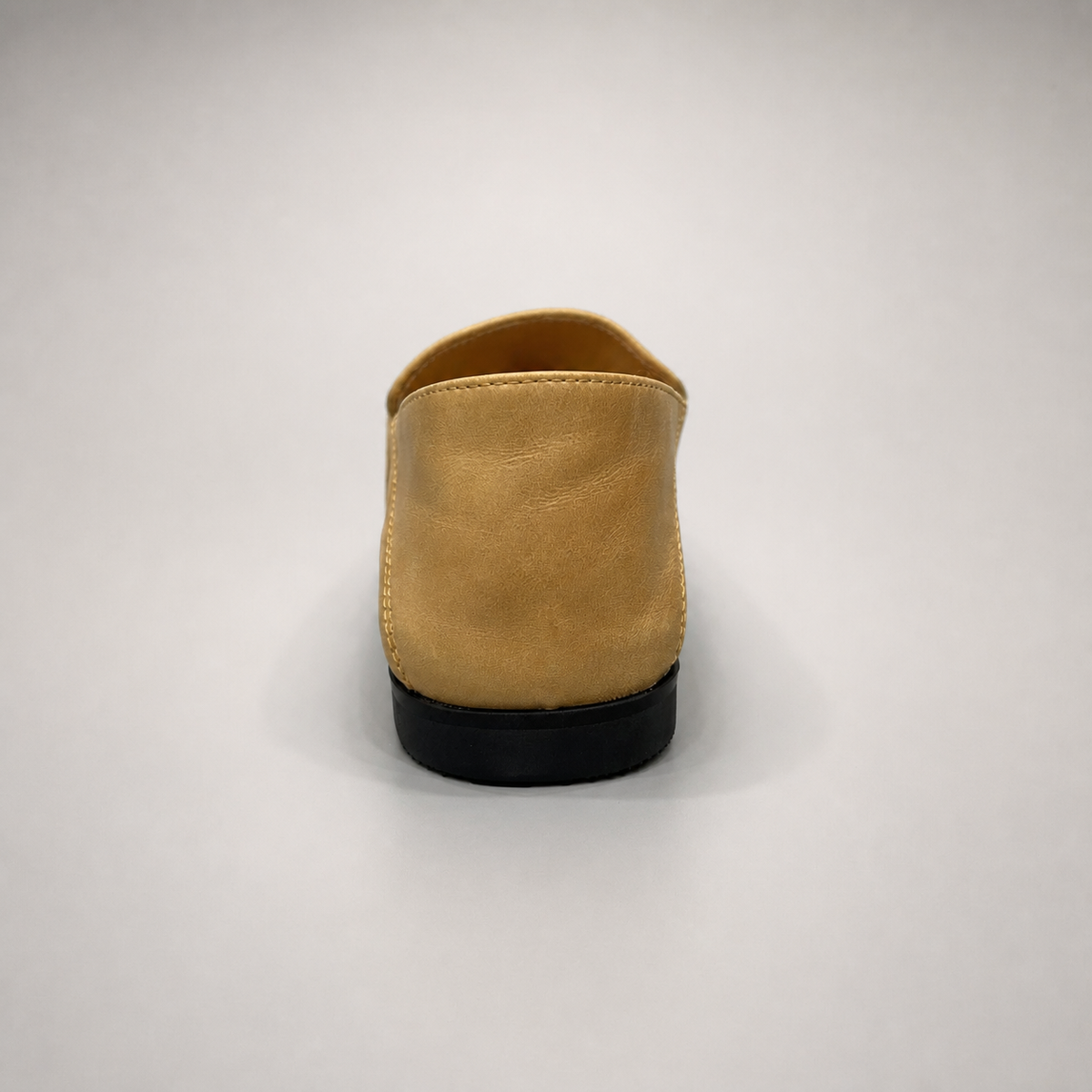 Tan loafer rear view showing a metal accent across the vamp